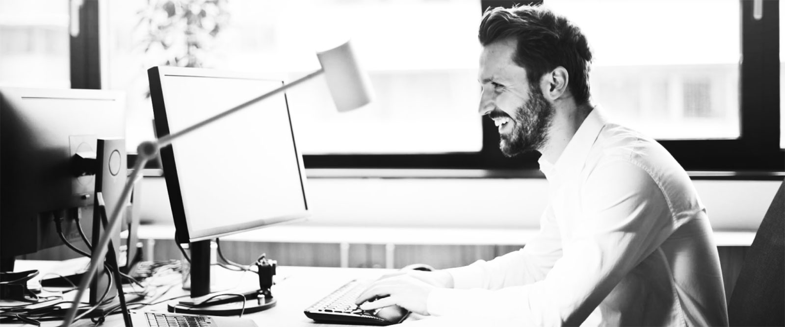 Man using a desktop computer in his office